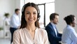 © Ariep - Smiling female call center agent with headset in modern office with customer support.
