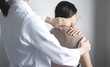 © Orathai - Female physiotherapists provide physical assistance to woman patients with shoulder injuries massaging their shoulders for muscle recovery in the rehabilitation center. Physiotherapy concepts