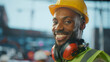© Videophilia - Smiling black construction worker wearing safety equipment on site