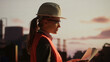 © Videophilia - Female engineer examining blueprint at refinery plant during sunset
