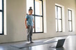 © Sergey - Child follows online yoga class in a bright, spacious room with large windows