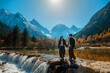 © Nichapa - Bipenggou national park Young couple tourist with the Beautiful  snow mountains in autumn, Chengdu ,Sichuan in China.