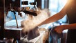 © Hungarian - A person cleaning a coffee machine with a cloth.