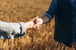 © Maria Vitkovska - Farmers shaking hands in a wheat field, making a deal for the future of agriculture