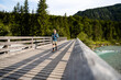 © Westend61 - Senior male hiking on a wooden bridge over a river in the mountains of Germany.