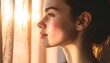 © Christian ezra - Young Woman Contemplating By Window In Warm Sunlight, Close-up of Skin Disease