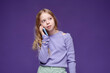 © VISTA by Westend61 - Girl using smartphone in studio with trendy vibe and purple background