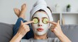 © Apzjr - A woman enjoying a playful and relaxing weekend self-care ritual with a clay face mask.