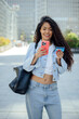 © VISTA by Westend61 - Woman using smartphone for online payment with credit card in city