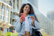 © VISTA by Westend61 - Woman using smartphone and credit card for online shopping outdoors