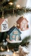 © fuad - Charming Ceramic House Ornaments Adorn a Festive Christmas Tree with Soft Bokeh Lights
