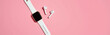 © fotoluigi868 - delicate array minimalist tech accessories sleek smartwatch earbuds arranged vibrant pink background symmetrical