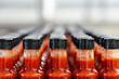 © HNstock - Many bottles of hot sauce waiting on conveyor belt in food processing plant