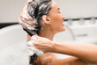 © Prostock-studio - Haircare Cosmetics. Woman Washing Head Applying Shampoo On Long Brown Hair Posing With Eyes Closed Sitting In Bathtub In Modern Bathroom At Home. Side View, Selective Focus