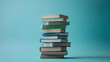© siti.h - Stack of books, various colors, teal background