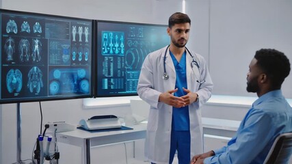Medical professional discussing a diagnosis with a patient using advanced digital screen technology in a modern clinic.