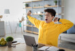 © Prostock-studio - Tired asian male student yawning sitting at desk using laptop. Bored guy is exhausted from getting ready for test or writing coursework, feeling sleepy, stretching arms. Lack of sleep and tiredness