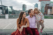 Heterosexual couple with their daughter on bridge in city