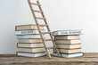 © HafijurRahaman - success goal ladder leaning on stacked books