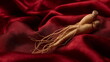 © Desmond - Ginseng traditional herb on premium red silk velvet cloth.