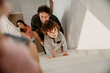 © Marko Geber - Happy young caucasian family playing together at home on a staircase