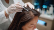 © Maksym - Close-up of gloved hands parting the patientâs hair as a fine mesotherapy needle approaches the scalp, magnifying lamp casting clinical white light, modern dermatology devices blur