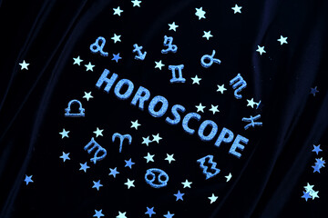abstract background with the inscription horoscope on a black velvet background.