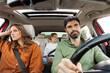 © Home-stock - Unhappy sad European family having quarrel while riding in car, man and woman expressing discontent in automobile while their daughter sitting on back seat