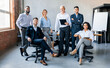 © Prostock-studio - Successful Business Team. Coworkers Smiling To Camera Posing At Workplace In Modern Office. Full Length