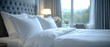© Tut Mandi - White bedding on a bed in a hotel room with a view.