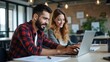 © Konstantin - Design professionals using a laptop together in an office