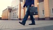 © Victoriia - Businessman walking on sidewalk, people walking. Office pedestrian walking on city street to work. City life of people. Man with briefcase in business suit walking on street from work. Business, city