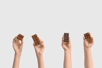 Wall Mural - Female hands with sweet chocolate on white background