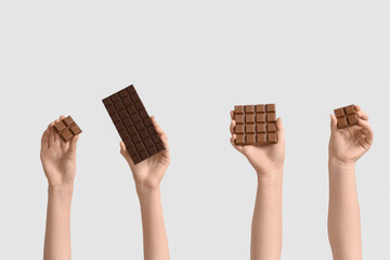 Wall Mural - Female hands with different sweet chocolate on white background