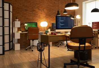 Wall Mural - interior of programmer's office with desks and glowing lamps in evening