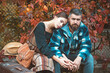 © Volodymyr - Couple in Autumn fall mood. Man and woman near Autumn fall leaves. Man and woman in love. Couple having a romantic moment together, dressing in traditional rural style on an autumn day.