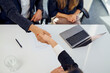 © BusinessClass by W61 - Recruiter shaking hand with candidate after successful interview at office