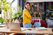 © BusinessClass by W61 - Happy businesswoman standing with arms crossed at desk in loft office