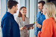 © BusinessClass by W61 - Happy businesswoman holding tablet PC and discussing with colleagues