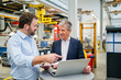 © BusinessClass by W61 - Manager pointing at laptop by businessman at factory