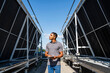 © BusinessClass by W61 - Employee with digital tablet checking refrigeration installation on rooftop