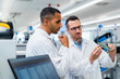 © BusinessClass by W61 - Two colleagues discussing over motherboard in electronics factory