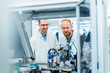 © BusinessClass by W61 - Colleagues in electronics factory watching machine work