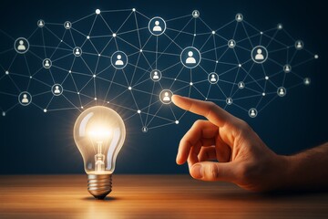 Wall Mural - hand touching digital network with glowing light bulb on wooden surface, symbolizing innovation and 