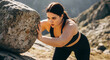 © Nadeesha - Overweight Woman Pushing Large Rock Uphill During Outdoor Fitness Challenge