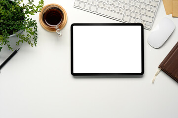 Wall Mural - top view of a digital tablet with a blank white screen on a minimalist desk