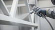 © Olesya - Builder painter spraying white paint onto metal construction. Craftsman using airbrush for industrial painting work. Factory maintenance.