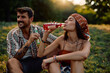 © Drazen - Young woman enjoying in summer drink while relaxing with her boyfriend in nature.