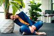 © BusinessClass by W61 - Mature businesswoman resting head on potted plant at workplace