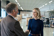 © BusinessClass by W61 - Happy blond businesswoman handshaking with colleague at warehouse